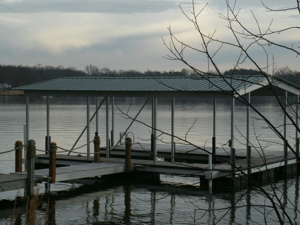 Lake Bowen Steel Floating Dock with Decking and Gable Roof Connected to Fixed Walkway.