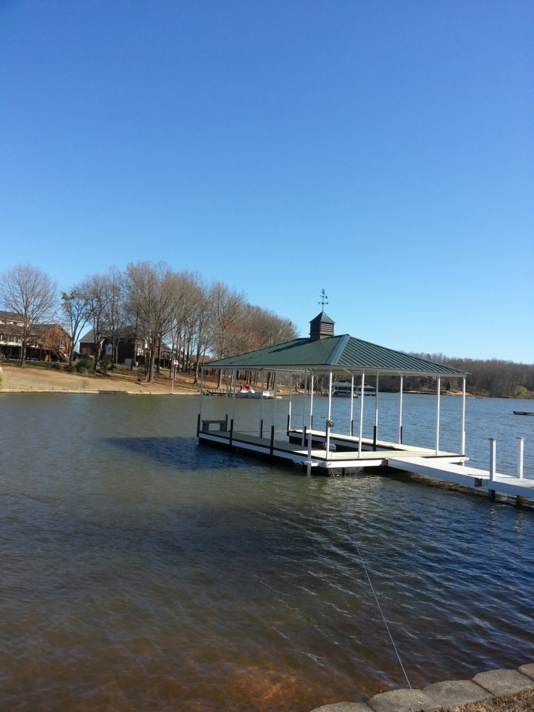 Steel Floating Dock with Aluminum Decking and Green Hip Roof and Weathervane